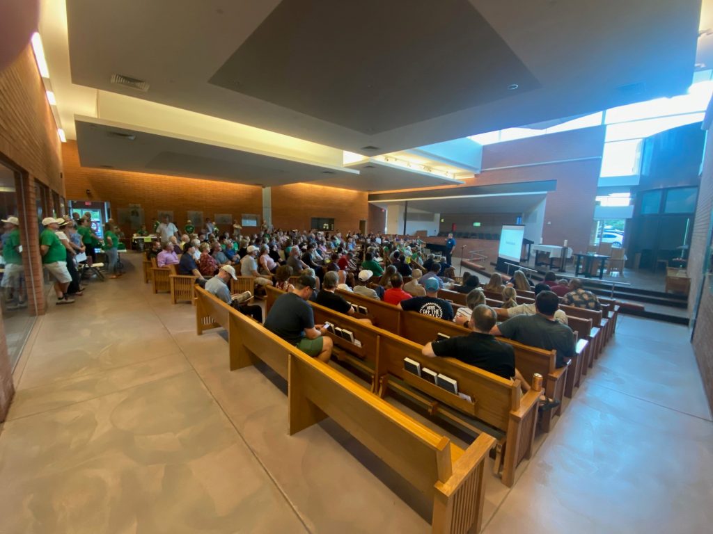 A photo of the inside of Church of the Epiphany in Tempe Arizona full of people at the 8/21/2024 community meeting